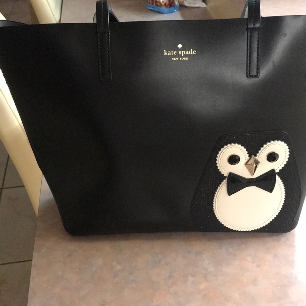 A really big Kate Spade penguin him back!